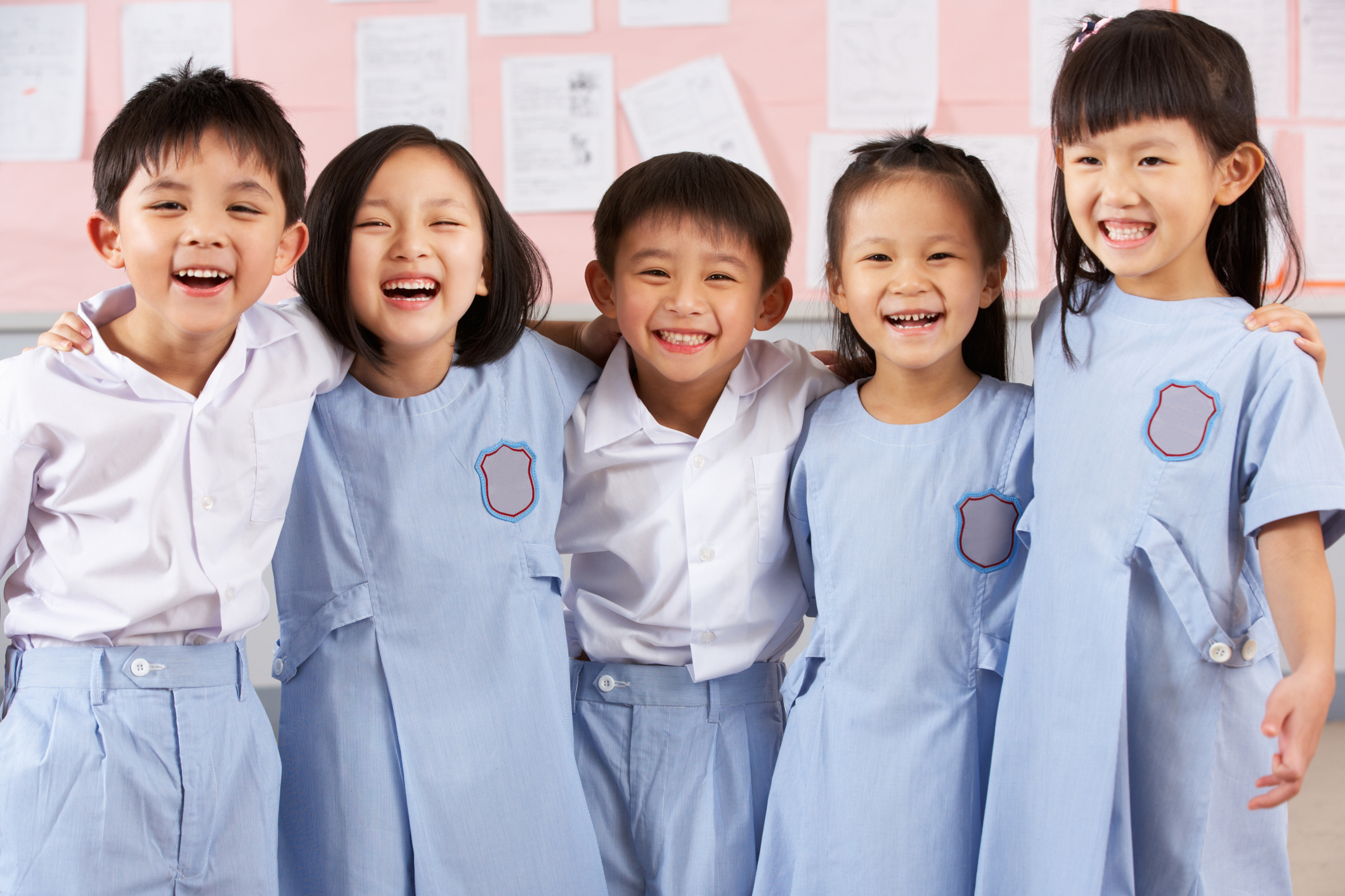 Portait Of Students In Chinese School Classroom Laughing At Camera