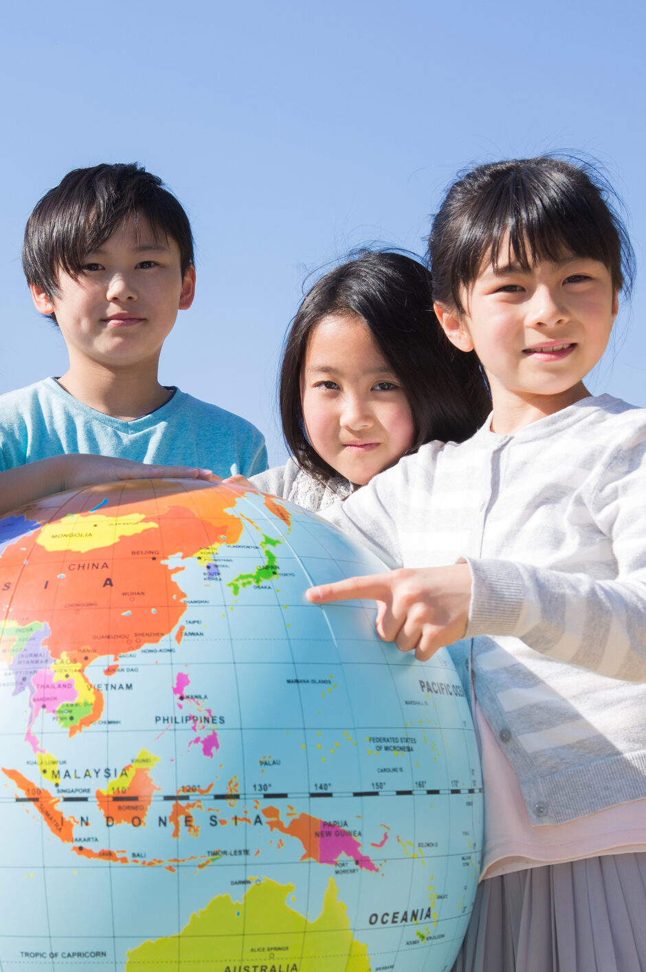 Elementary school students with globe