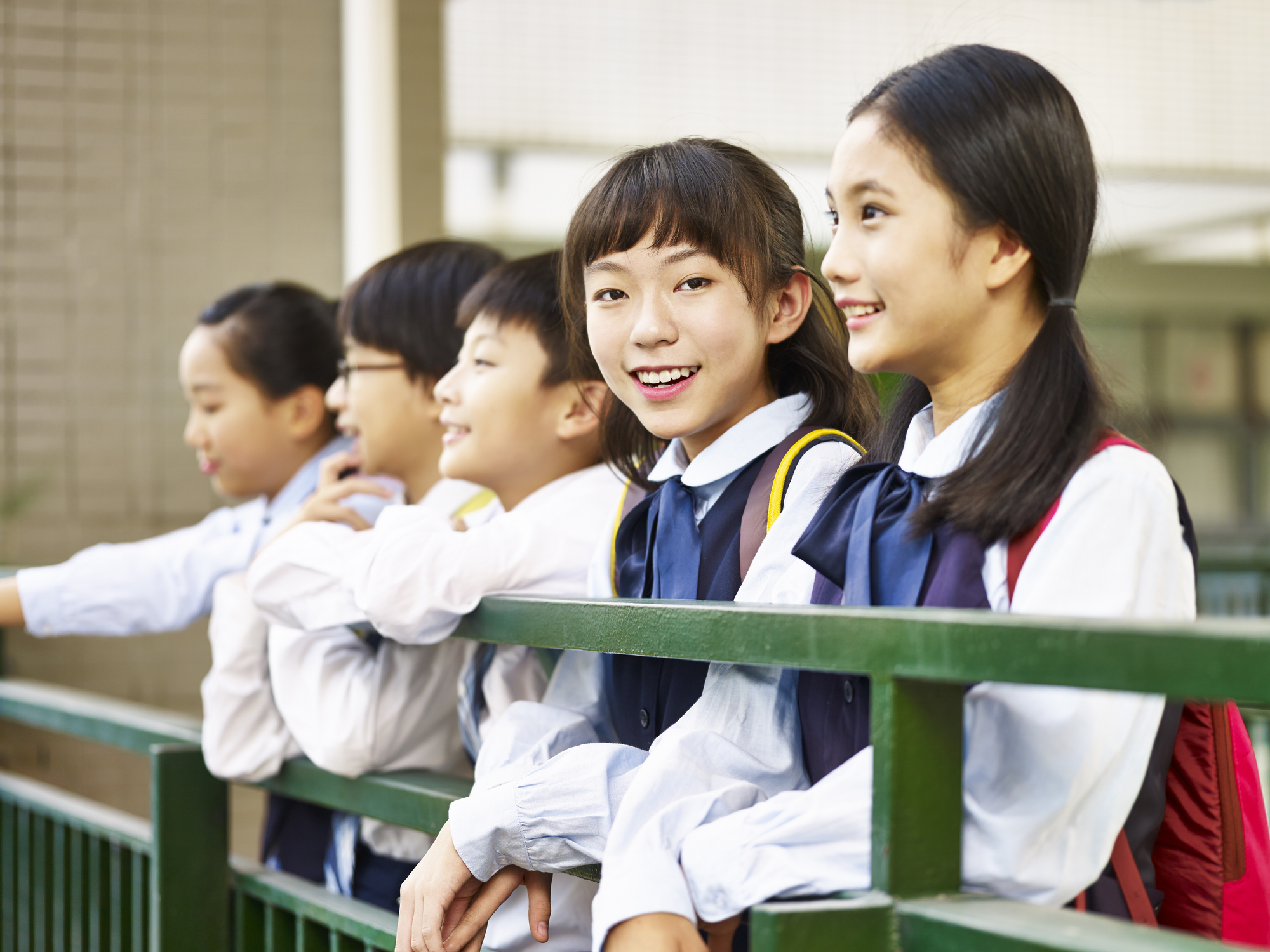 portrait of a group of asian elementary school children wearing uniform.